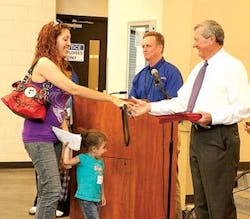 Greehey (in white) congratulates a Haven for Hope graduate. Greehey (in white) congratulates a Haven for Hope graduate.