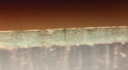 An X50 side view of a whitewashed 2.5° bend exhibits through-coating cracks (Fig. 6). An X50 side view of a whitewashed 2.5° bend exhibits through-coating cracks (Fig. 6).