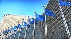 Waving EU flags in front of European Commission in Brussels, Belgium. Waving EU flags in front of European Commission in Brussels, Belgium.