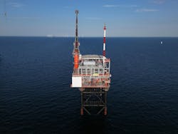 Production platform N05-A in the Dutch North Sea with view of windfarm in the background. Production platform N05-A in the Dutch North Sea with view of windfarm in the background.