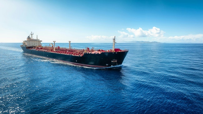 Aerial view of a heavy crude oil tanker traveling with speed over the ocean