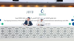 two men signing contracts at a table at a conference two men signing contracts at a table at a conference