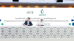 two men signing contracts at a table at a conference two men signing contracts at a table at a conference