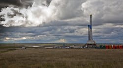 Drilling rig in North Dakota under cloudy sky Drilling rig in North Dakota under cloudy sky