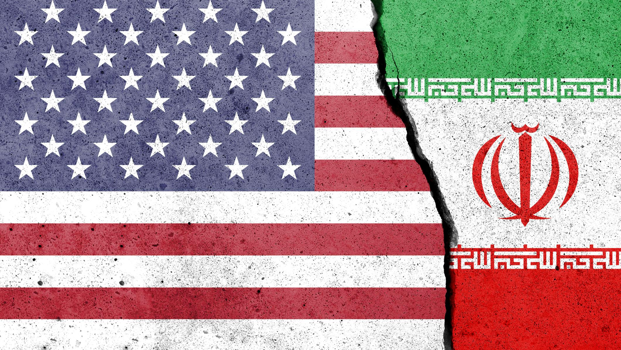 US and Iran flags painted on concrete with a break down the center