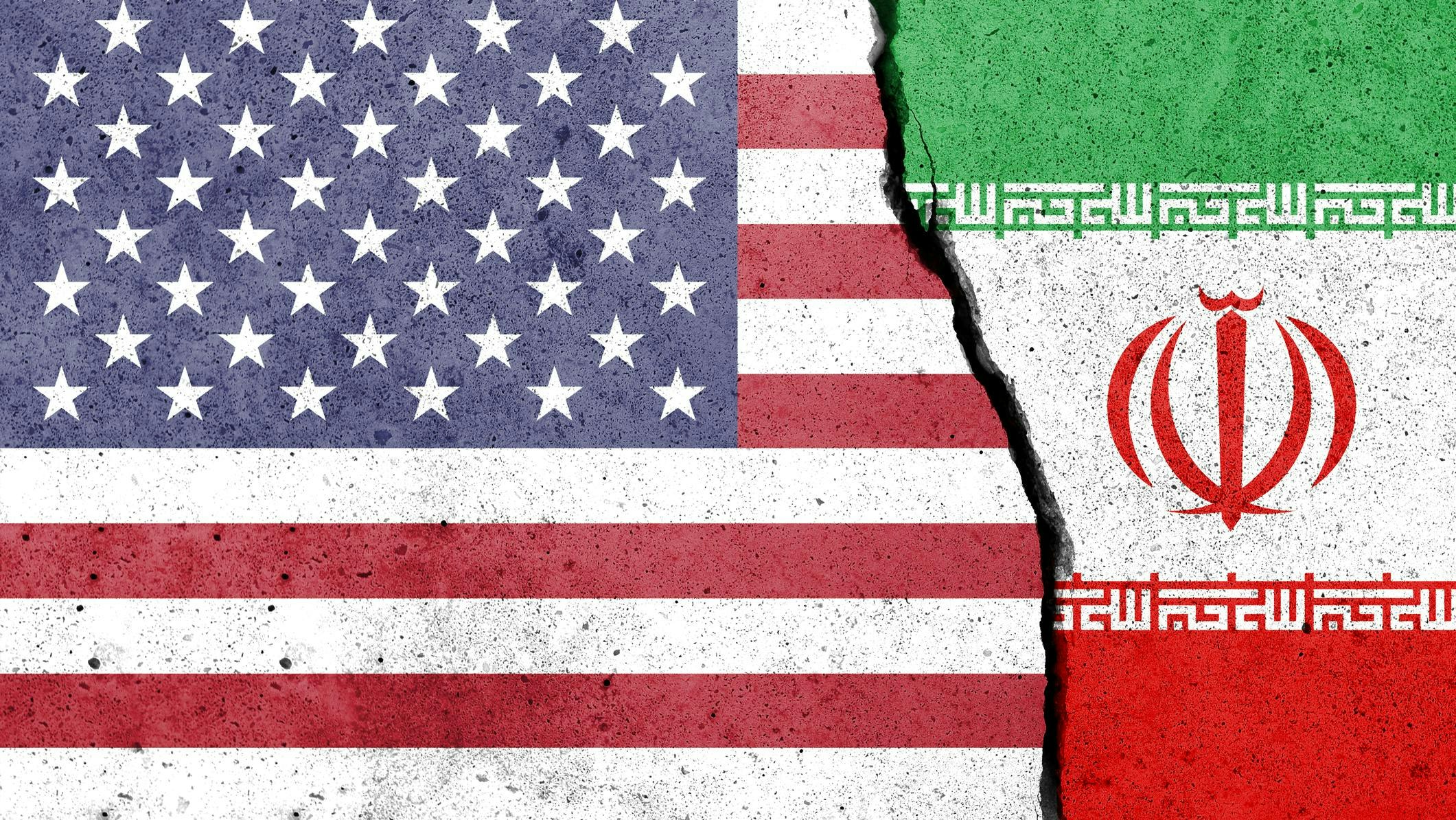 US and Iran flags painted on concrete with a break down the center
