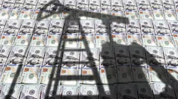 oil equipment shadow on US currency background