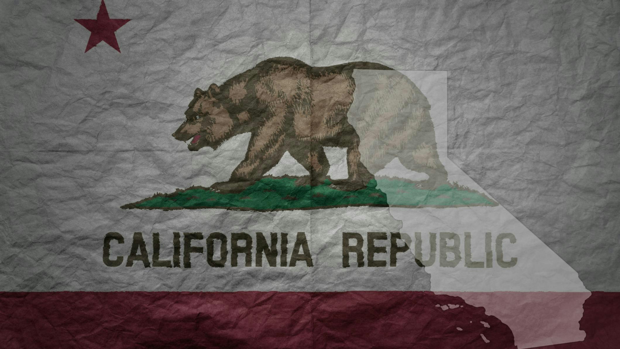 California flag and outline map of California on paper texture background