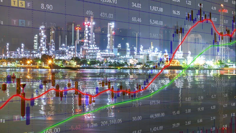 red and green line graph over spreadsheet data and refining operations photo