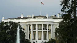 View of the US White House with water fountain and trees in foreground View of the US White House with water fountain and trees in foreground