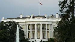 View of the US White House with water fountain and trees in foreground View of the US White House with water fountain and trees in foreground