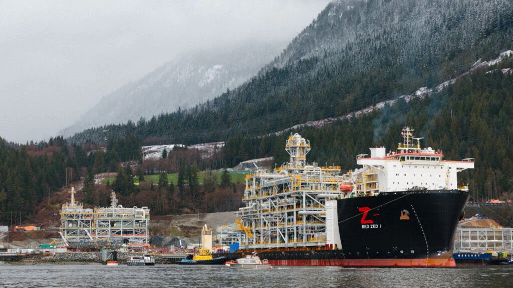 A heavy cargo vessel pulls a natural gas liquefaction module offshore British Columbia