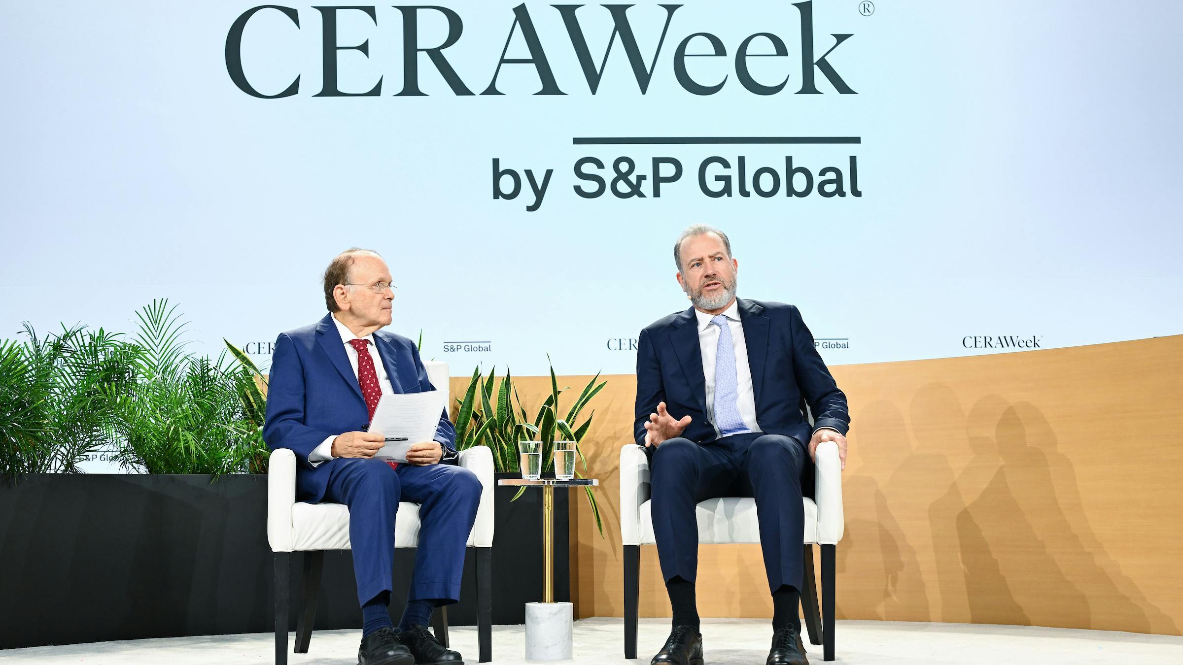 two men in suits seated for a leadership discussion