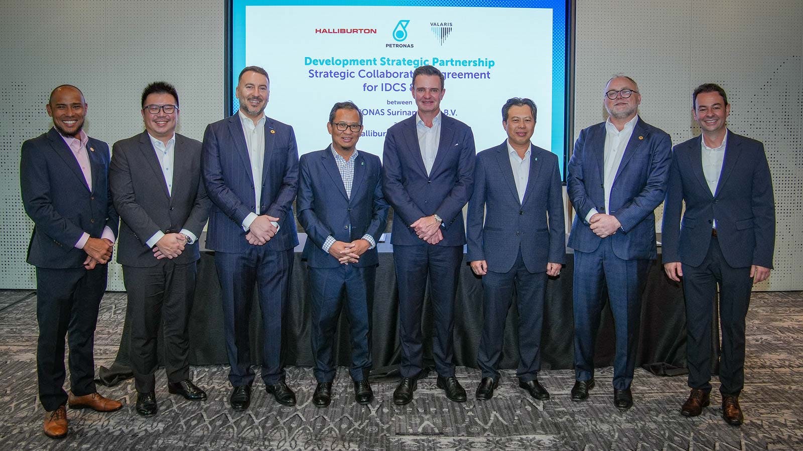 Men from Petronas, Valaris, and Halliburton stand together following signing of an agreement