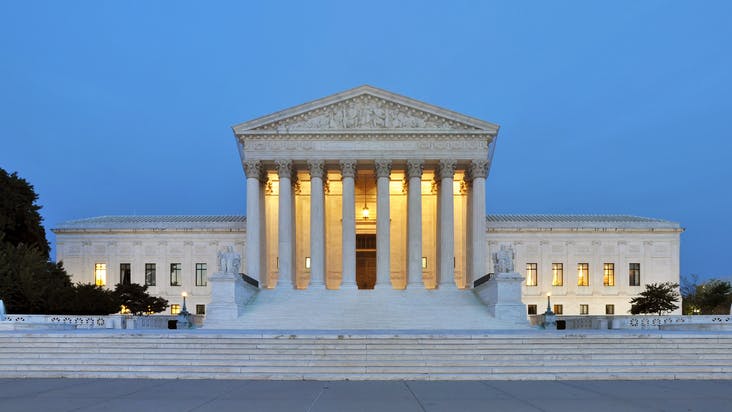 Supreme Court building at dusk in Washington, DC, USA.