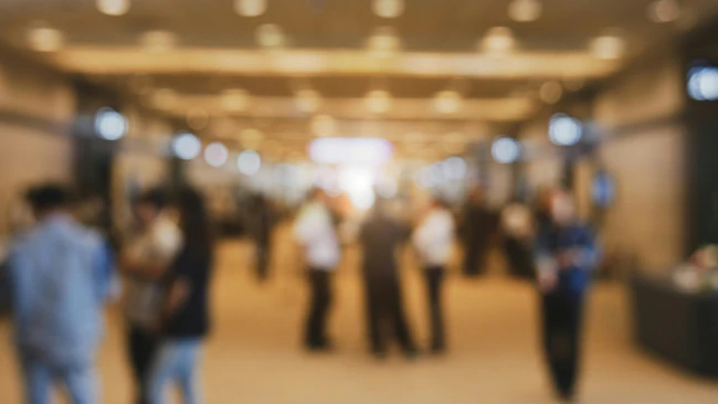 blurred photo of exhibition hall attendees