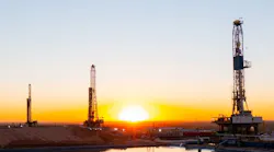 Diamondback oil and gas operations at sunset Diamondback oil and gas operations at sunset