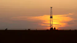 drilling rig onshore at sunset drilling rig onshore at sunset