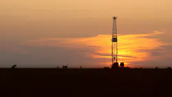 drilling rig onshore at sunset drilling rig onshore at sunset