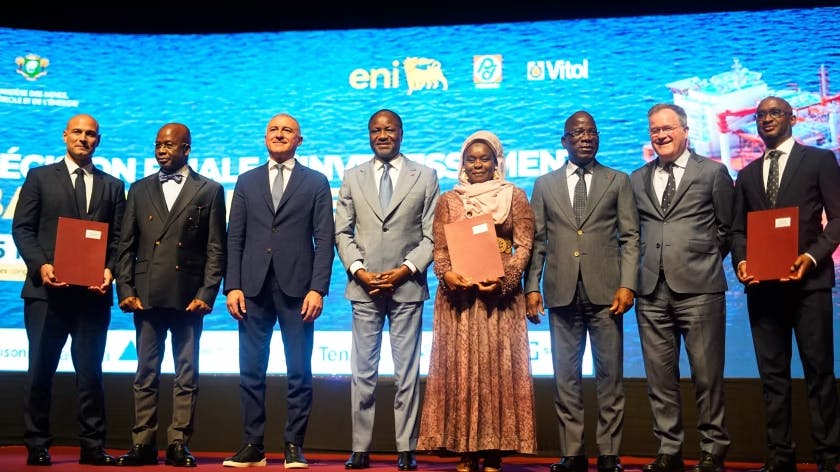 Eni, Petroci, and Vitol representatives, along with Ivory Coast's Minister of Mines, Petroleum and Energy, stand during a signing ceremony