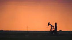 Silhouette of active oil pump shot at sunset Silhouette of active oil pump shot at sunset