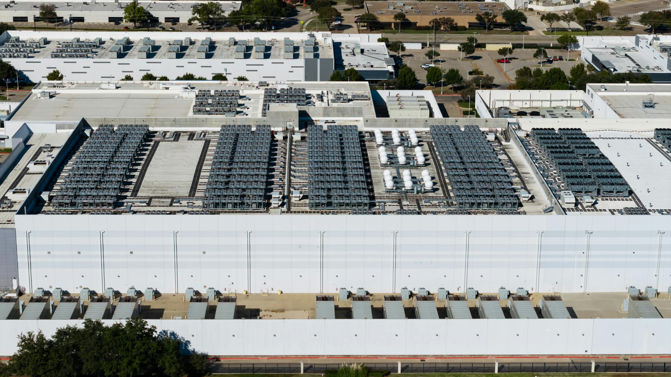 Data center building roof with cooling units generating computing power