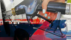 An oil tanker and a person refueling diesel at a petrol station