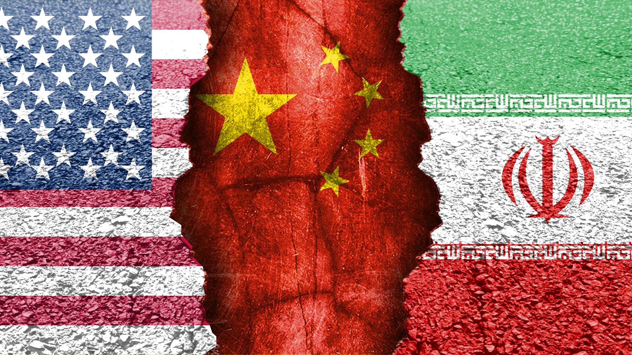 Flag representation of geopolitical tensions. Flags of the US, China, and Iran.