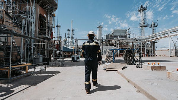 An employee walking through infrastructure at Montana Renewables' Great Falls renewable fuels production plant