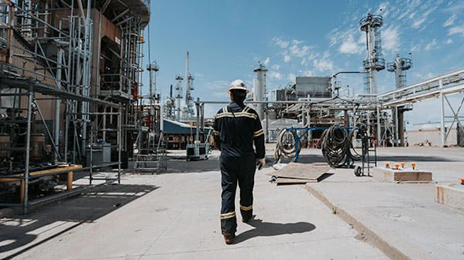 An employee walking through infrastructure at Montana Renewables' Great Falls renewable fuels production plant