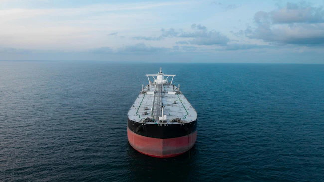 Aerial view of the front of a large crude oil tanker ship at sea.