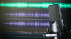 podcast mic in front of audio recording software screen