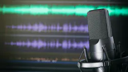 podcast mic in front of audio recording software screen