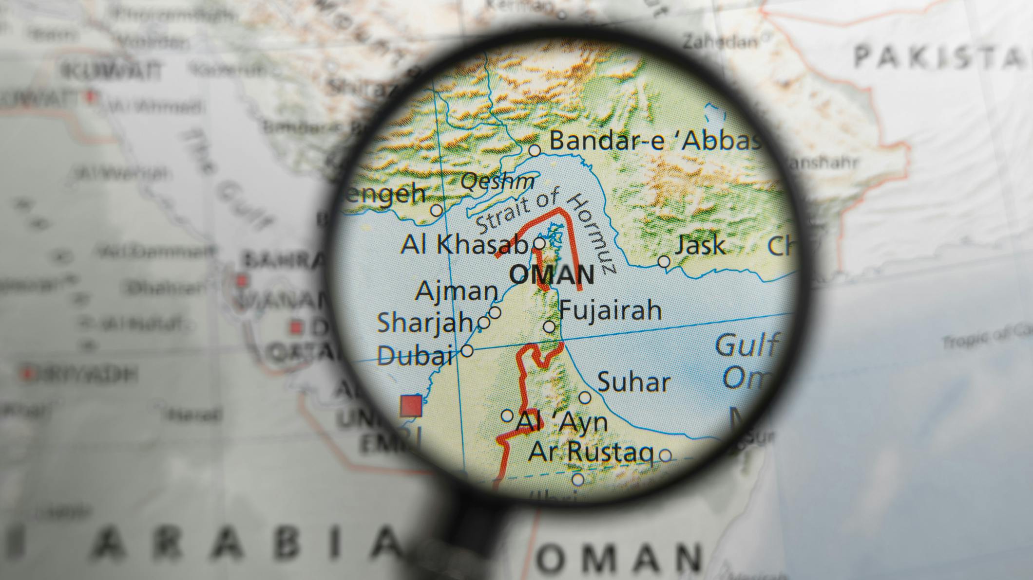 Map with Strait of Hormuz under a magnifying glass