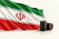 Iranian flag fluttering against a background of white behind two oil barrels.