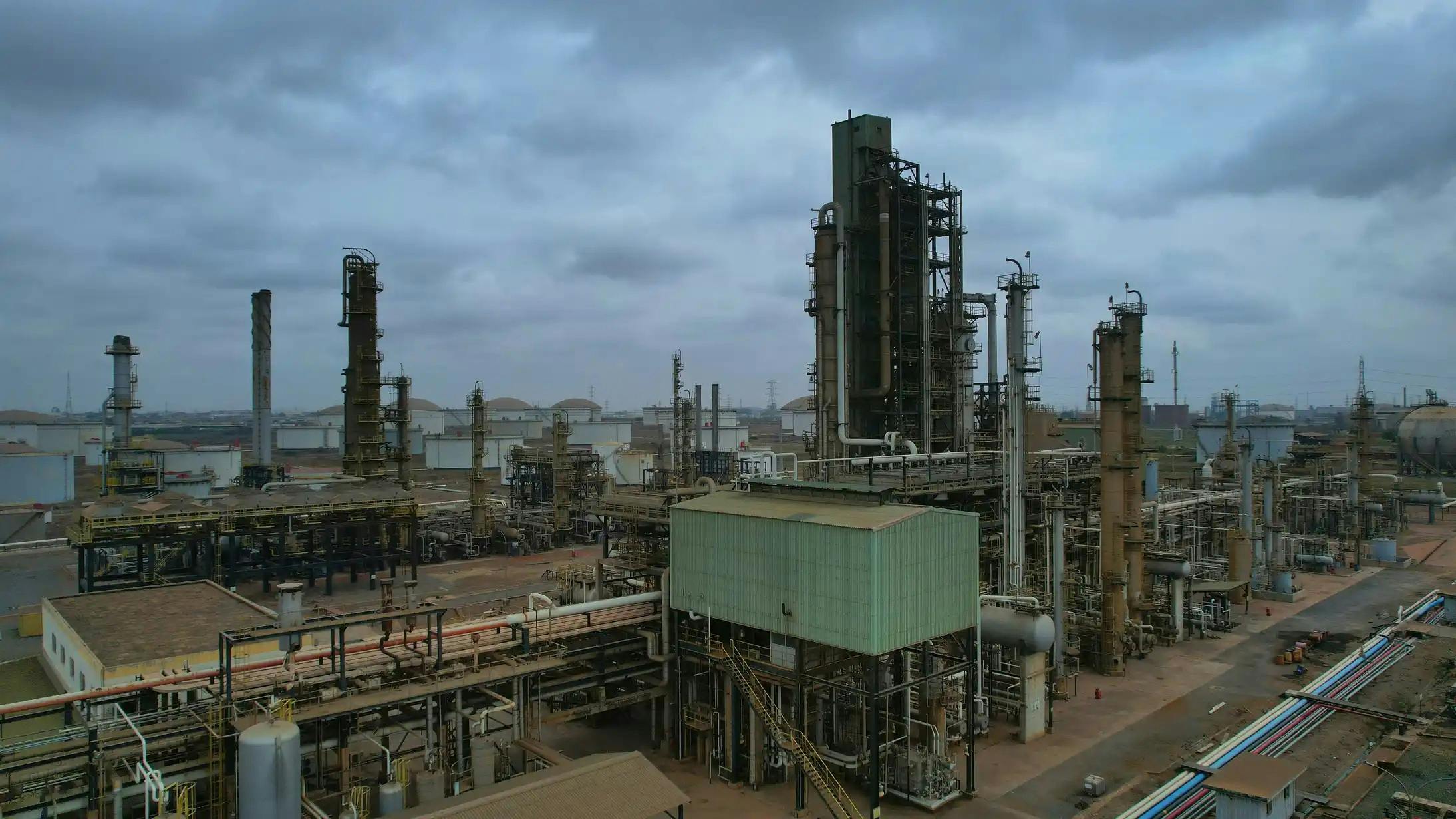 Panoramic view of processing and production installations under a cloudy sky at TOR's existing Tema oil refinery.