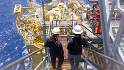 Two workers on stairs at Shell's Whale oil and gas platform in the US Gulf of Mexico