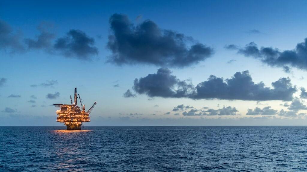 Offshore oil and gas platform at night