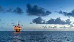Offshore oil and gas platform at night